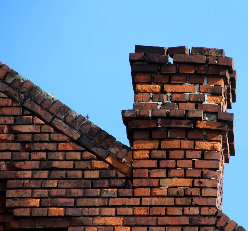 Damaged chimney on an River Forest home showing cracks and missing mortar